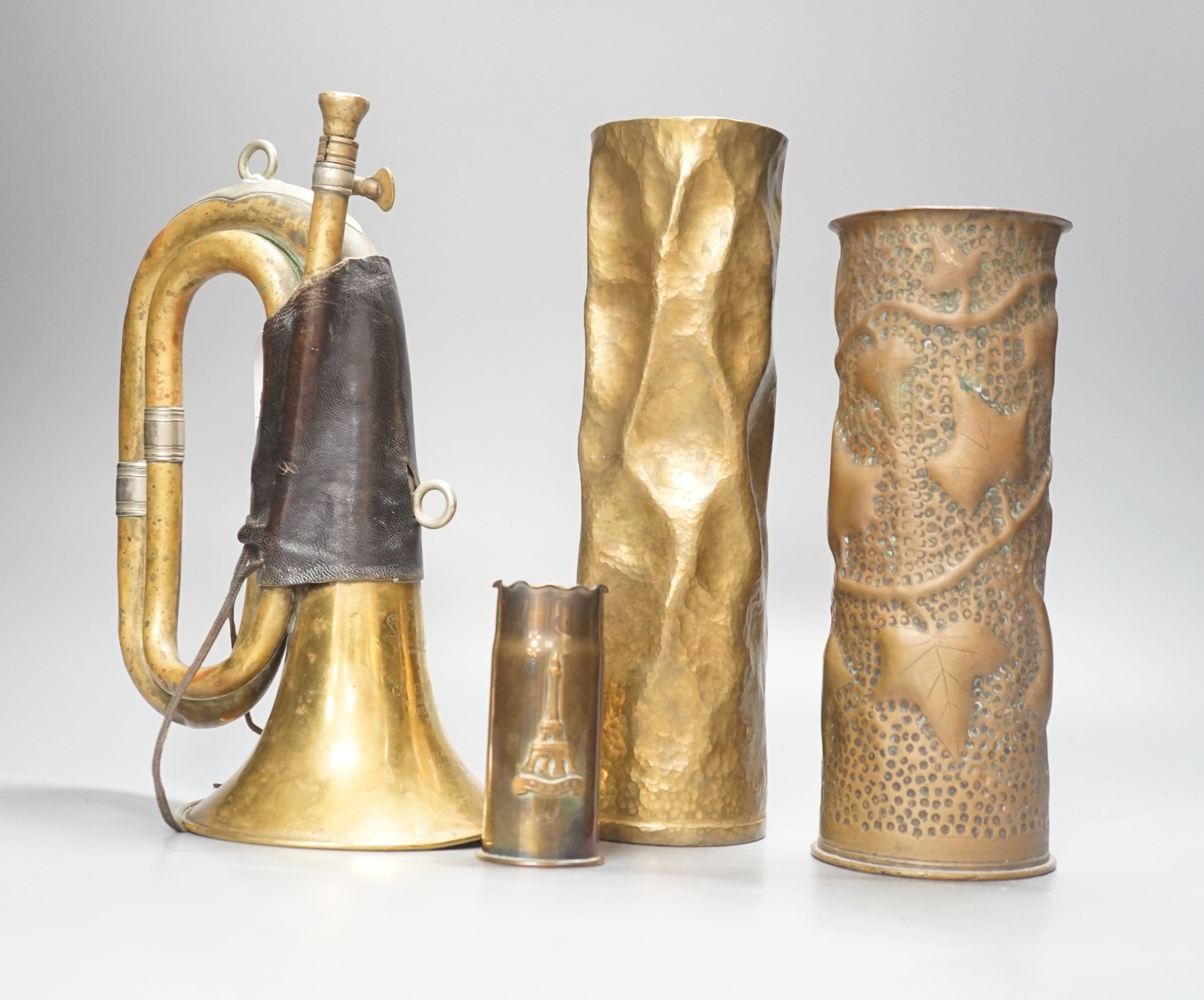 Three WWI brass trench art shell cases and a Couesnon & Cie brass bugle